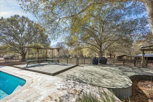 a view of a house with swimming pool and sitting area