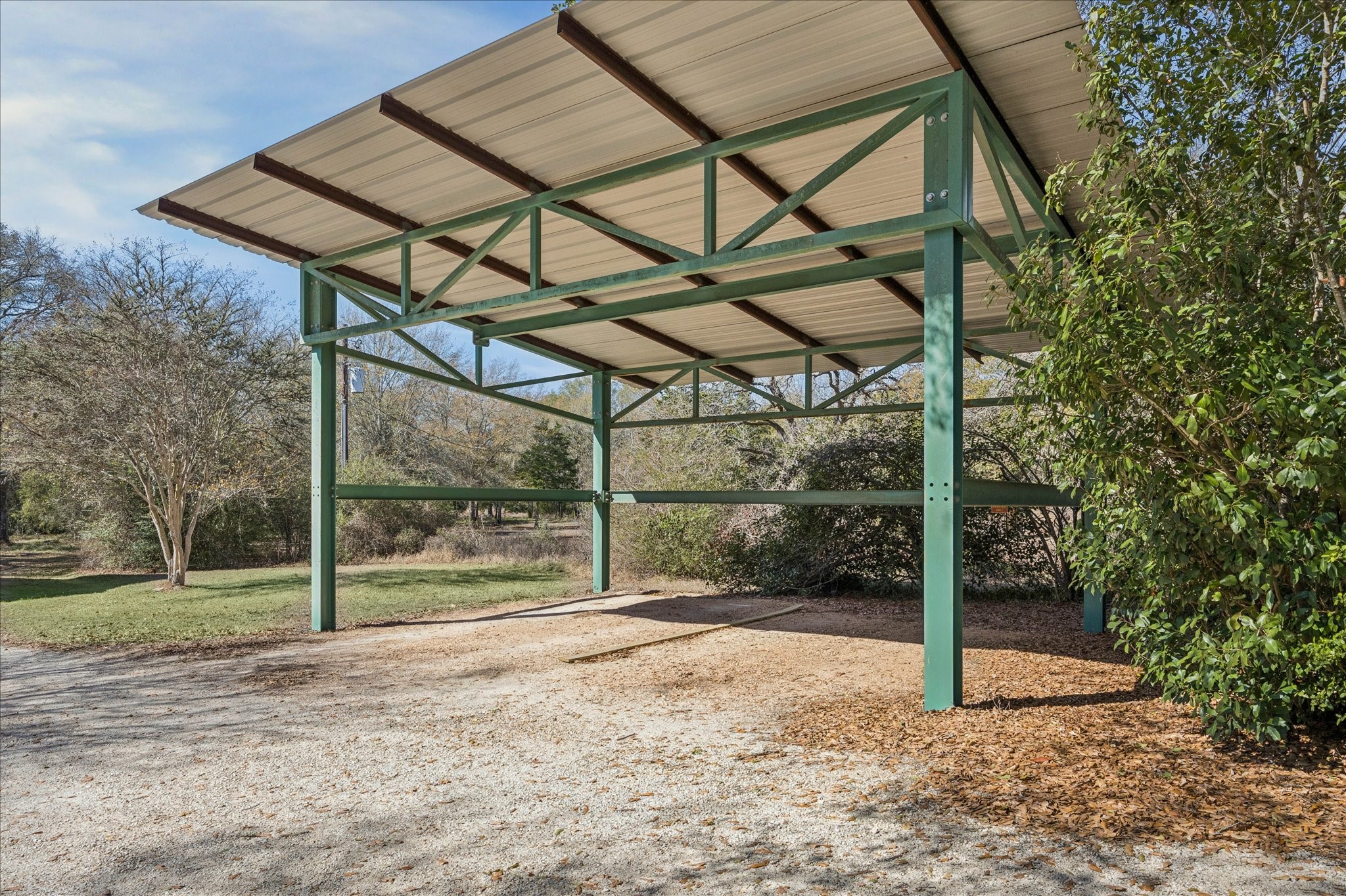 640 Piney Creek Road Bellville, TX 77418 - Photo 29 of 31 The property includes a secondary carport, providing ample space for an RV, boat, or extra vehicle parking.