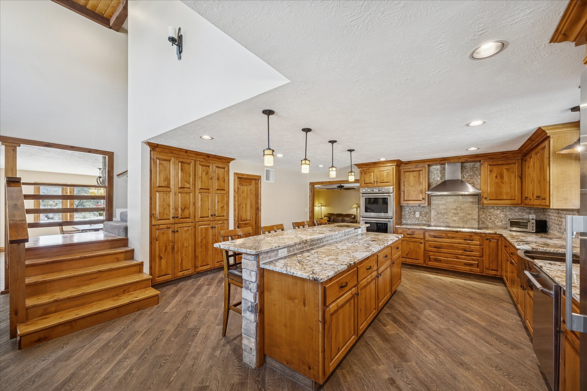 640 Piney Creek Road Bellville, TX 77418 - Photo 4 of 31 A chef’s dream kitchen featuring an eat-in island and custom cabinetry offering abundant storage.