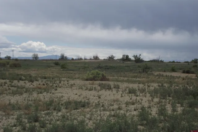 a view of a lake and green valley
