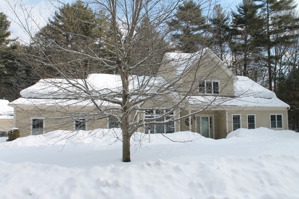 a view of house with a yard covered in snow