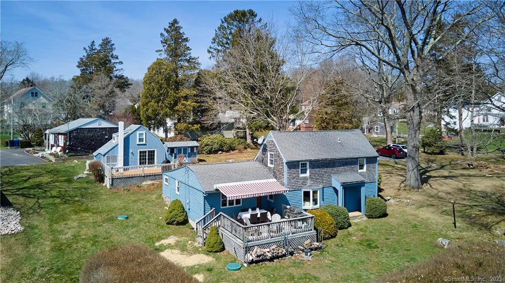 an aerial view of a house with swimming pool and trees