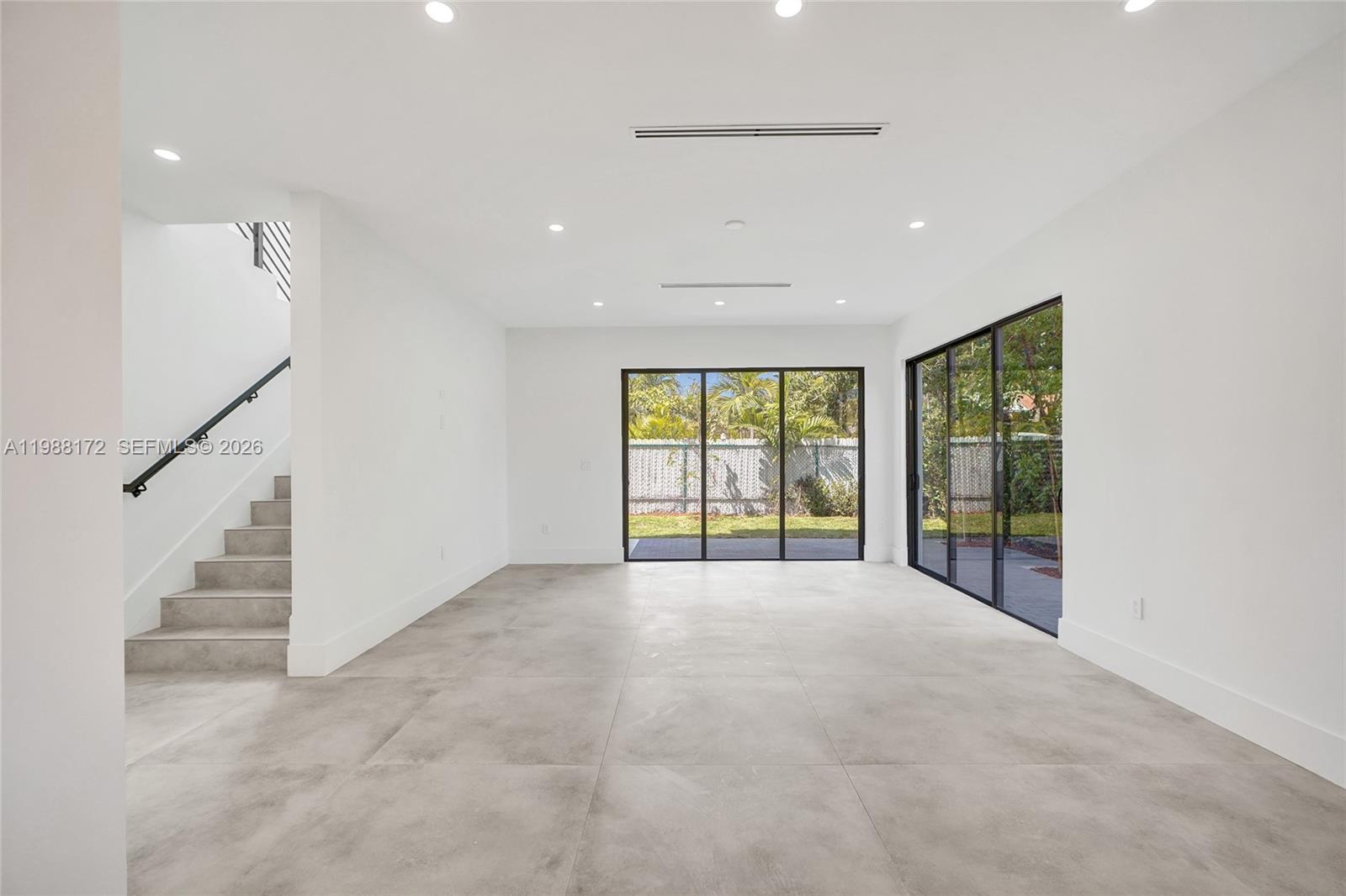 2421 Southwest 16th Terrace Miami, FL 33145 - Photo 12 of 37 a view of an empty room with wooden floor and a window