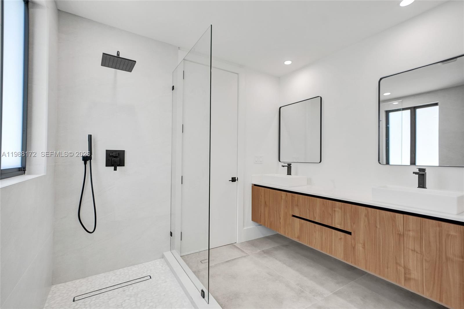 2421 Southwest 16th Terrace Miami, FL 33145 - Photo 17 of 37 a bathroom with a double vanity sink a mirror and shower