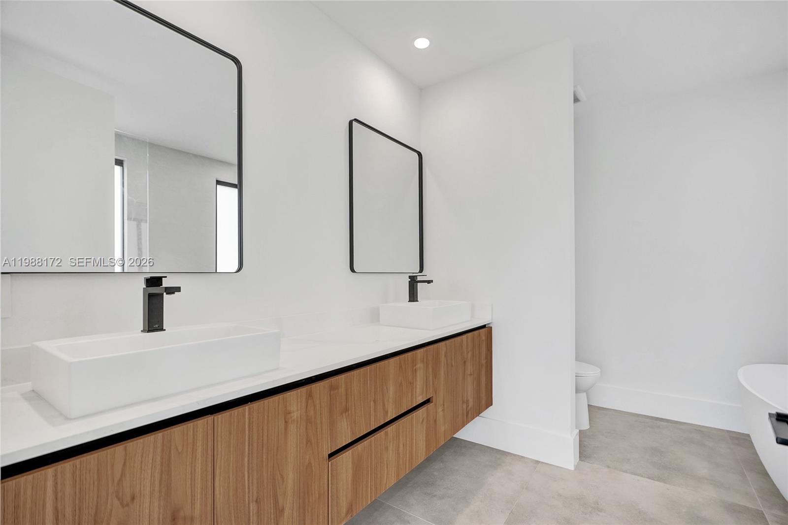 2421 Southwest 16th Terrace Miami, FL 33145 - Photo 18 of 37 a bathroom with a sink and a mirror