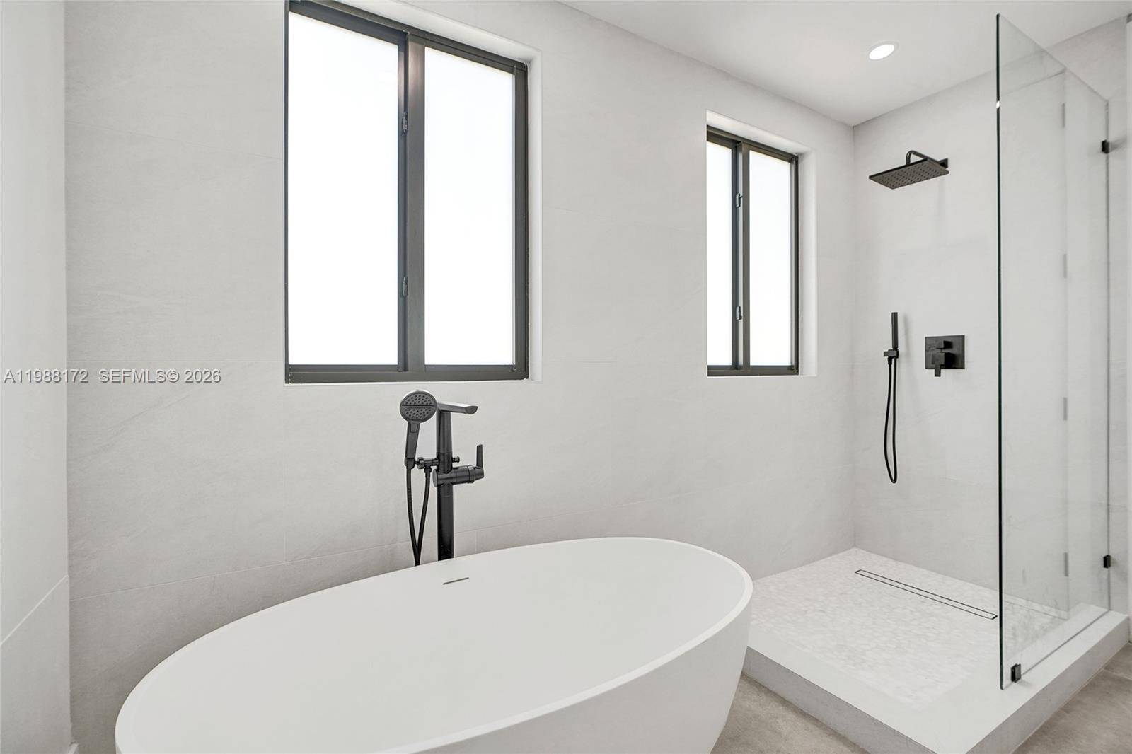 2421 Southwest 16th Terrace Miami, FL 33145 - Photo 19 of 37 a bathroom with a bathtub and a shower