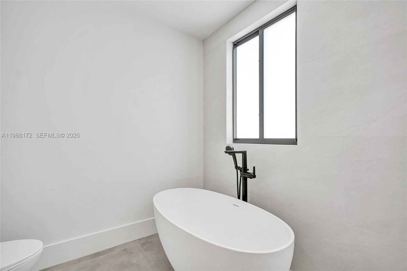 2421 Southwest 16th Terrace Miami, FL 33145 - Photo 20 of 37 a bathroom with a toilet a sink and a window
