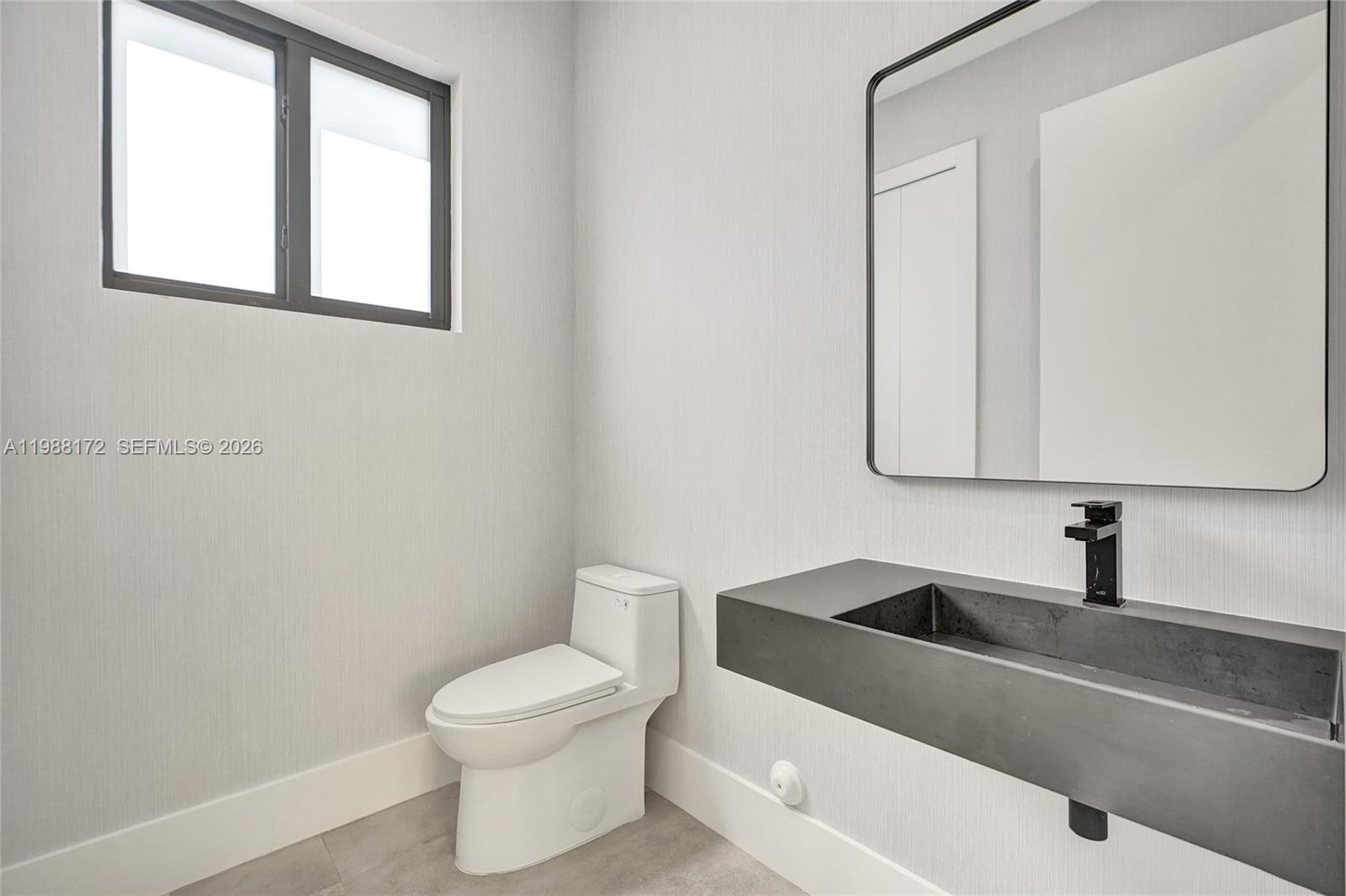 2421 Southwest 16th Terrace Miami, FL 33145 - Photo 34 of 37 a bathroom with a toilet a sink and mirror