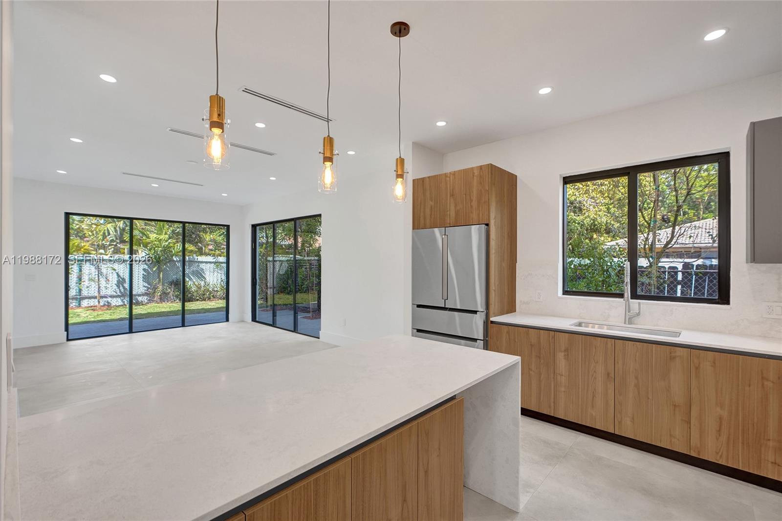 2421 Southwest 16th Terrace Miami, FL 33145 - Photo 7 of 37 a view of an empty room with a window and kitchen view