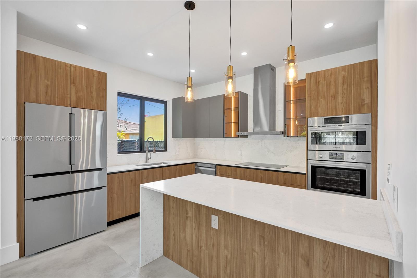 2421 Southwest 16th Terrace Miami, FL 33145 - Photo 8 of 37 a kitchen with stainless steel appliances a refrigerator and a sink