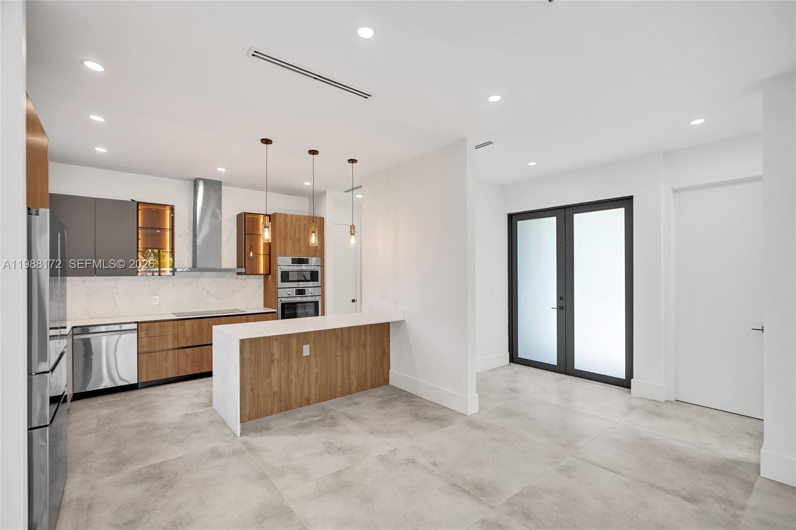 2421 Southwest 16th Terrace Miami, FL 33145 - Photo 9 of 37 a large kitchen with stainless steel appliances granite countertop a refrigerator and a stove top oven