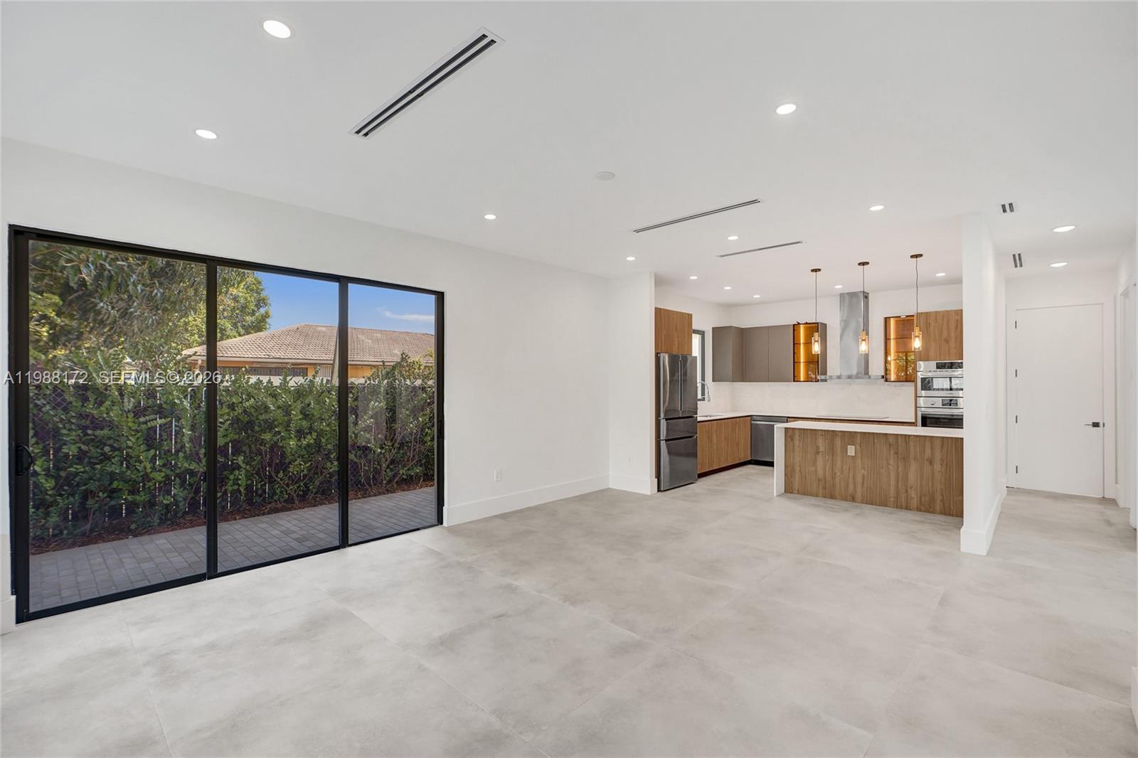 2421 Southwest 16th Terrace Miami, FL 33145 - Photo 10 of 37 a large white kitchen with large windows and kitchen view