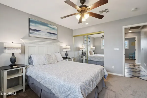 a bathroom with a granite countertop sink vanity mirror and toilet
