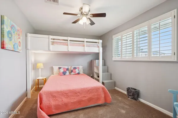 a bathroom with a granite countertop sink mirror and a toilet