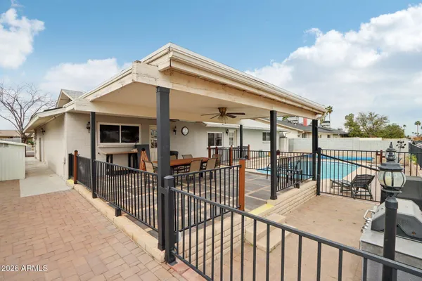 a view of a patio with a dining table and chairs