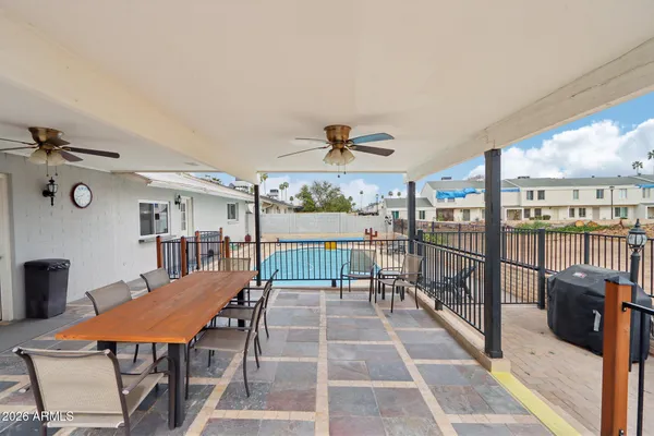 a view of a house with large porch and furniture