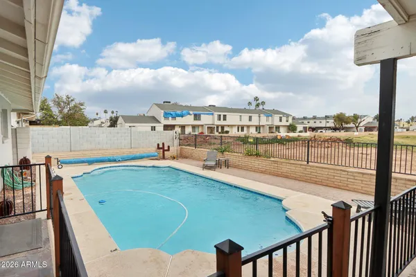 a dining room with furniture and a floor to ceiling window