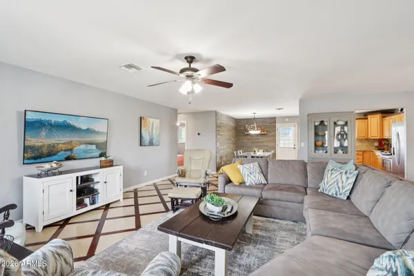 a living room with furniture ceiling fan and a rug