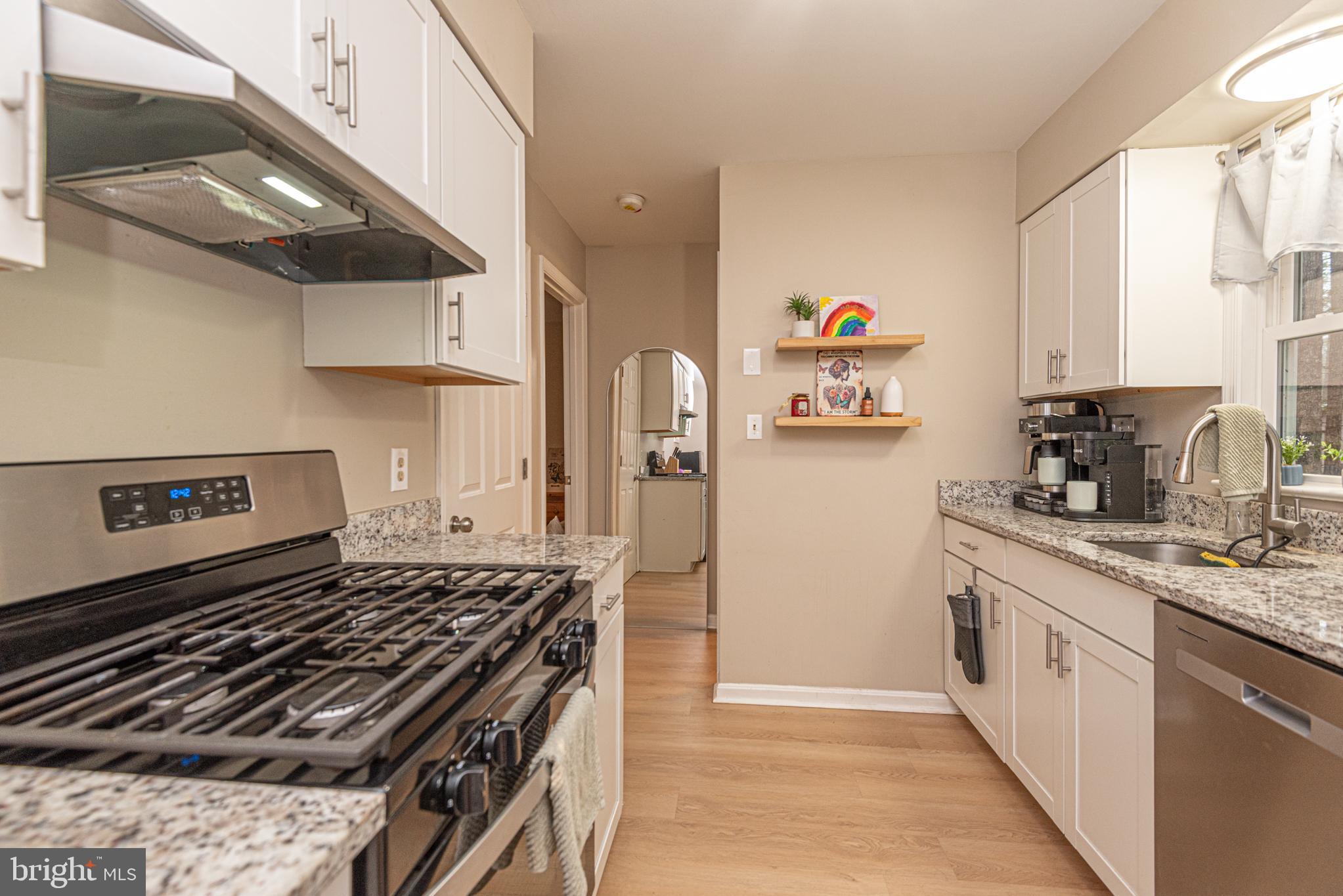 33 Liberty Street Ocean Pines, MD 21811 - Photo 11 of 30 a kitchen with stainless steel appliances granite countertop a stove and a sink