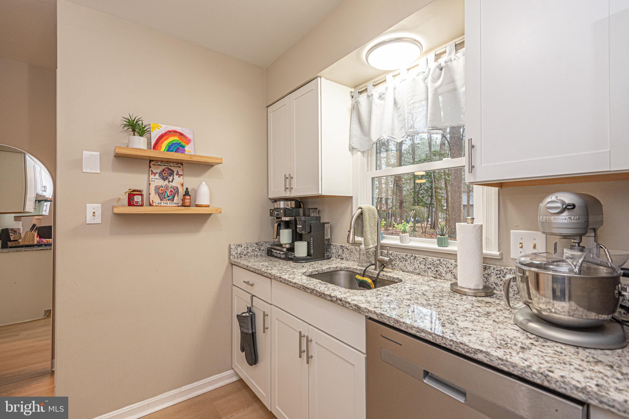 33 Liberty Street Ocean Pines, MD 21811 - Photo 12 of 30 a kitchen with stainless steel appliances granite countertop a sink and a wooden floor