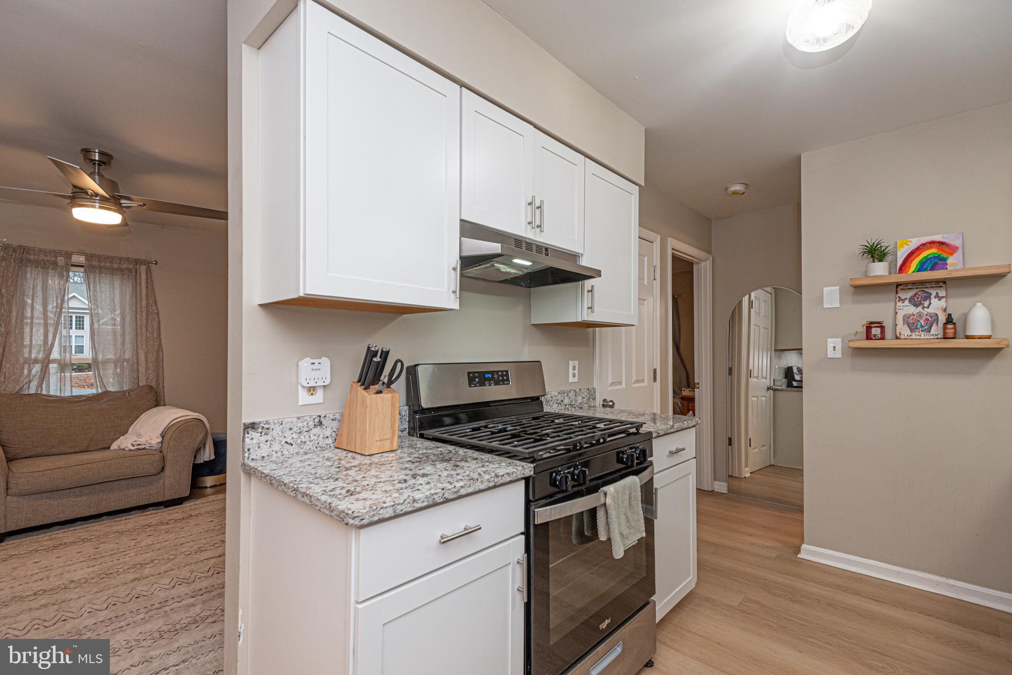 33 Liberty Street Ocean Pines, MD 21811 - Photo 14 of 30 a kitchen with granite countertop stainless steel appliances a sink stove and refrigerator