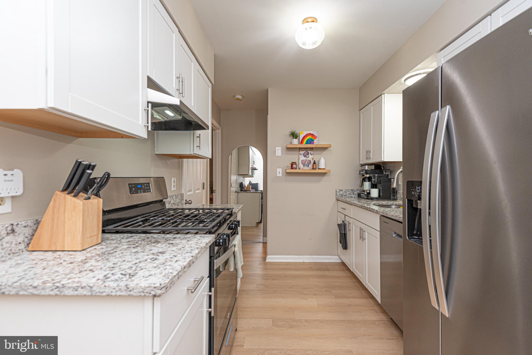 33 Liberty Street Ocean Pines, MD 21811 - Photo 10 of 30 a kitchen with stainless steel appliances granite countertop a sink stove and refrigerator