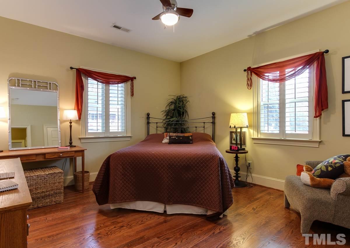 2711 Barmettler Street Raleigh, NC 27607 - Photo 13 of 25 a bedroom with a bed and wooden floor