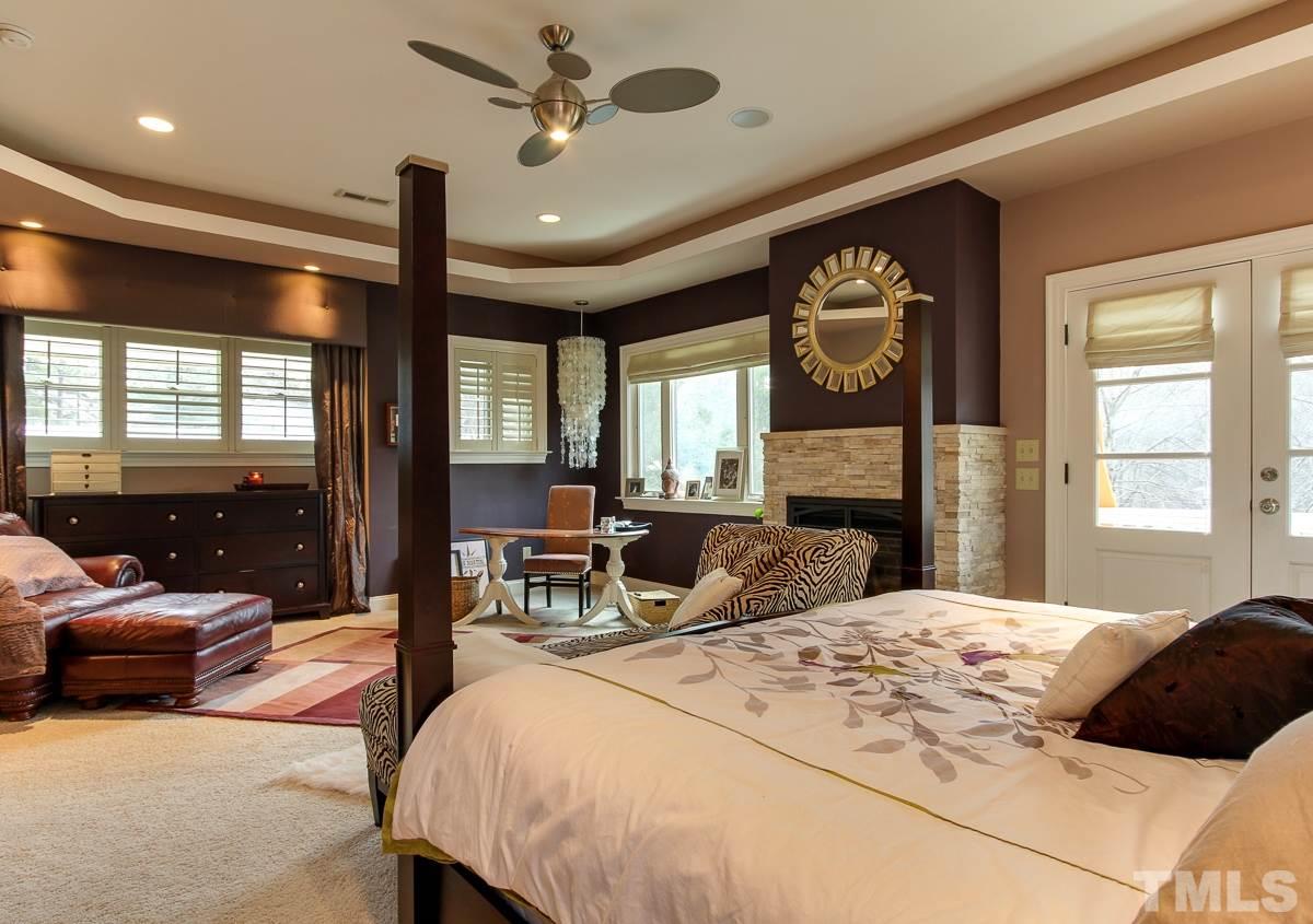 2711 Barmettler Street Raleigh, NC 27607 - Photo 17 of 25 a bedroom with a bed large window with ceiling fan and a rug