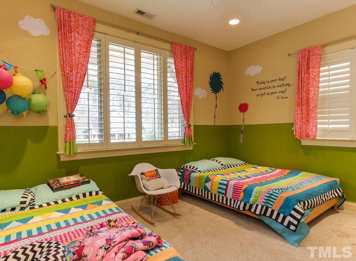 2711 Barmettler Street Raleigh, NC 27607 - Photo 21 of 25 a bedroom with a bed and windows