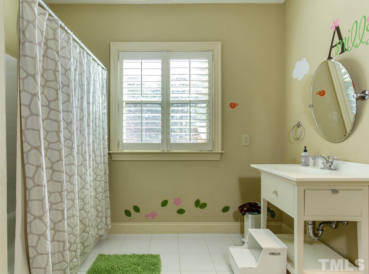 2711 Barmettler Street Raleigh, NC 27607 - Photo 22 of 25 a bathroom with a sink and a mirror