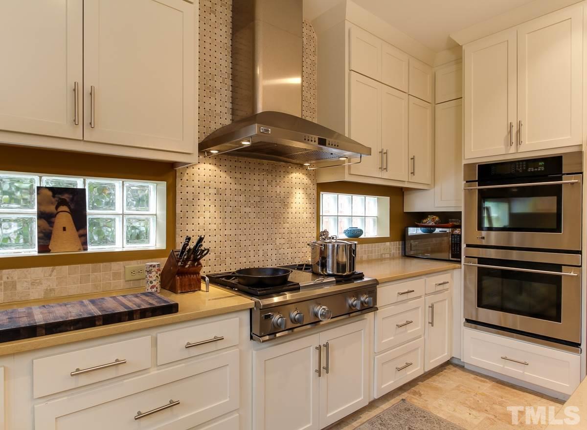 2711 Barmettler Street Raleigh, NC 27607 - Photo 9 of 25 a kitchen with granite countertop a stove and a sink