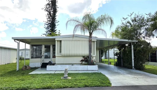 a front view of a house with garden and patio