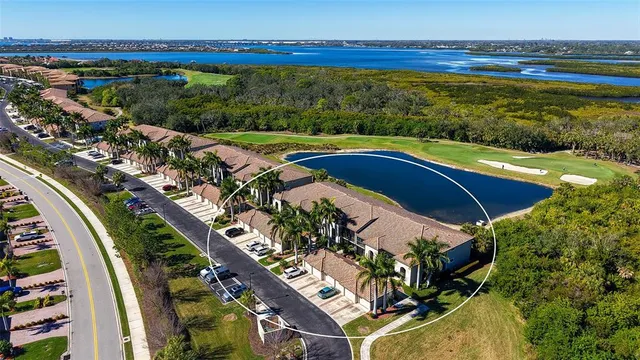 an aerial view of residential houses with outdoor space and swimming pool