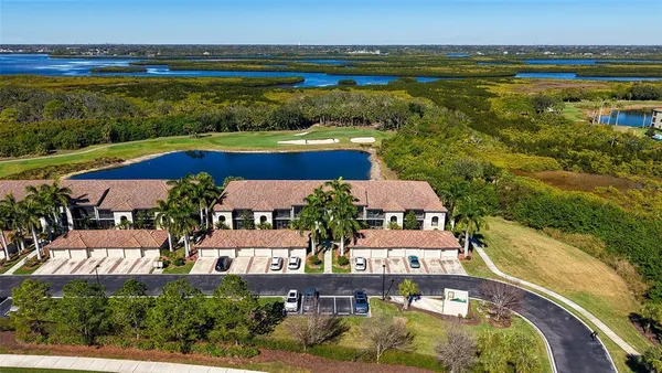 an aerial view of residential houses with outdoor space and swimming pool