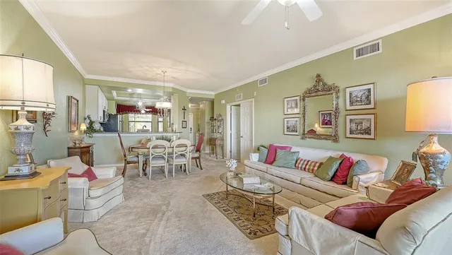 a view of a dining room with furniture a chandelier and window