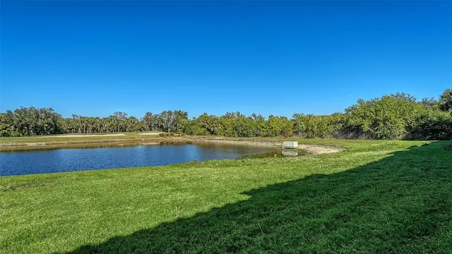 a view of a patio with furniture and a table and chairs under an umbrella