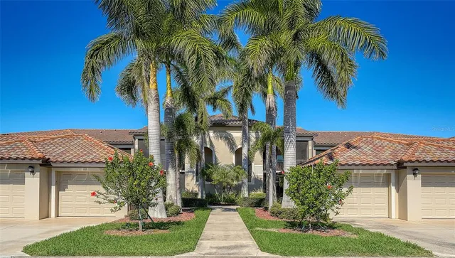 a view of a house with a yard and plants