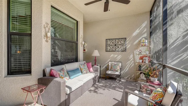 a living room with furniture and a floor to ceiling window