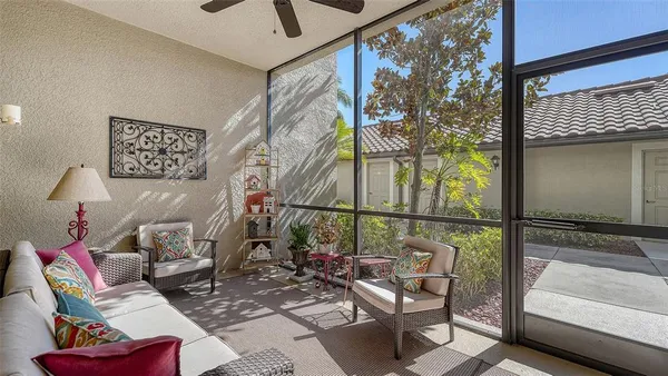 a living room with furniture and a floor to ceiling window