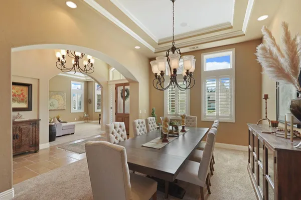a living room with furniture and a ceiling fan