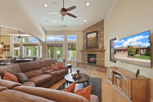 a bedroom with a large bed and a chandelier