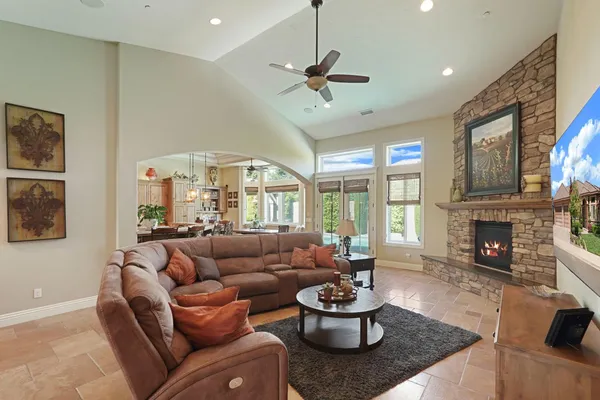 a bedroom with a large bed and a chandelier
