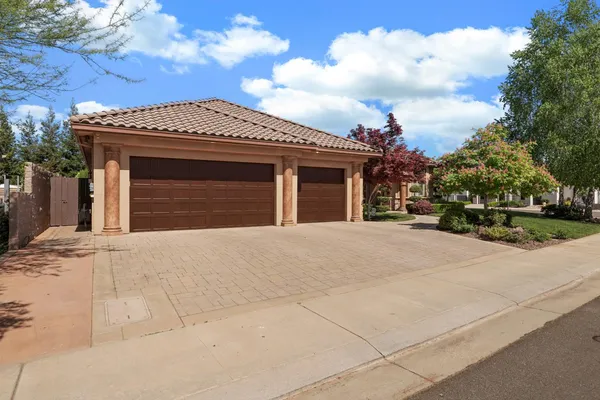 an aerial view of a house with a yard and garden