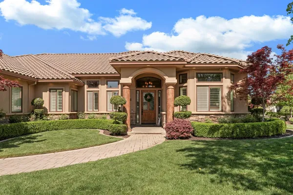 an aerial view of a house with a garden and swimming pool