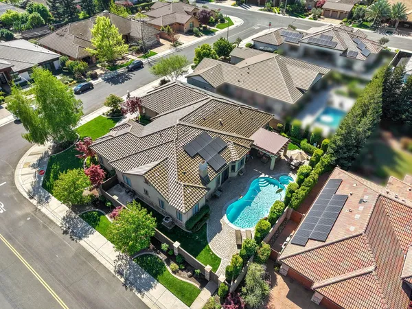 an aerial view of a city with lots of residential buildings and ocean view in back