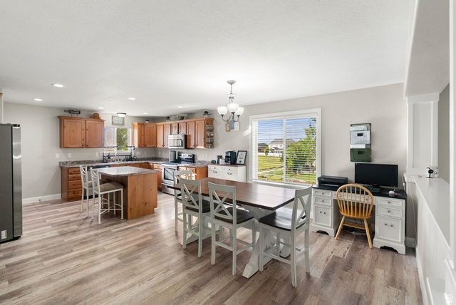 2485 South 1100th Street West Logan, UT 84321 - Photo 14 of 53 Open-concept kitchen featuring wood-finish flooring, recessed lighting, and a kitchen island with seating