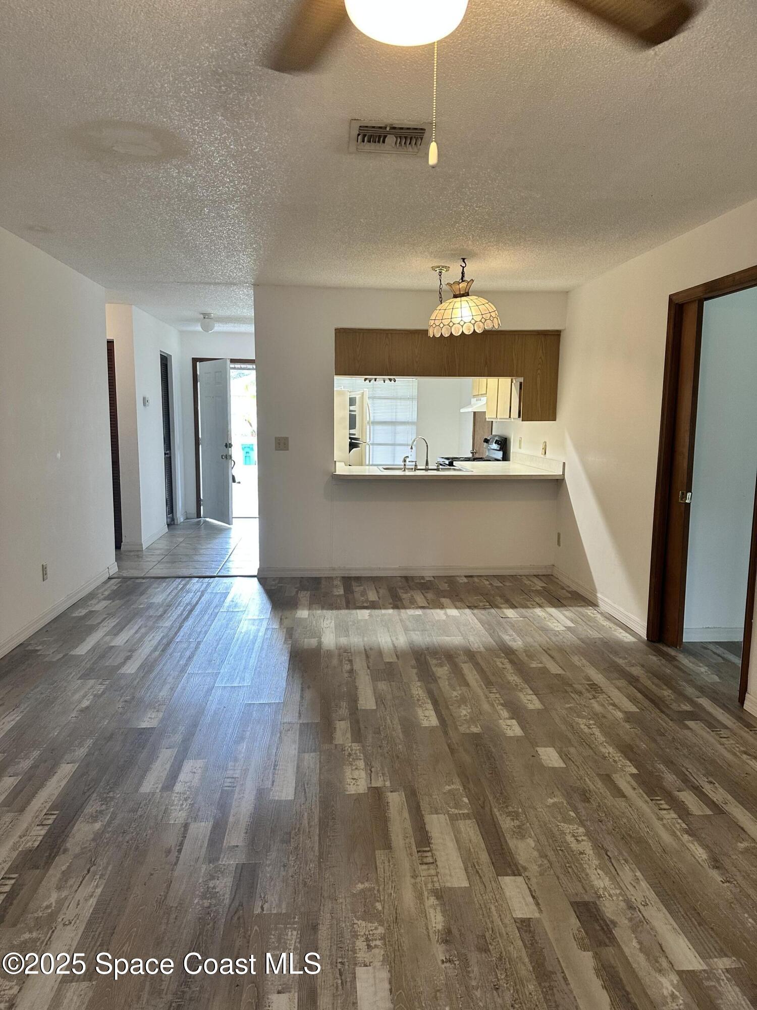 1610 Santos Street Southeast, Unit B Palm Bay, FL 32909 - Photo 3 of 4 wooden floor in an empty room with a window