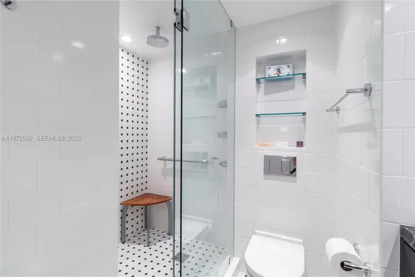 a bathroom with a shower toilet and sink