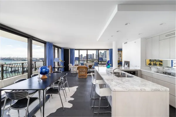 a living room with furniture and floor to ceiling windows