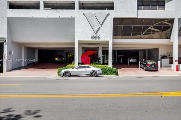 a view of a cars park in front of the building
